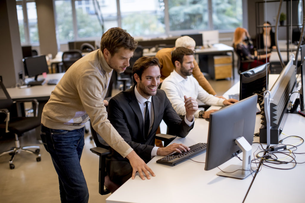 Senior businesswoman and young business people work in the modern office